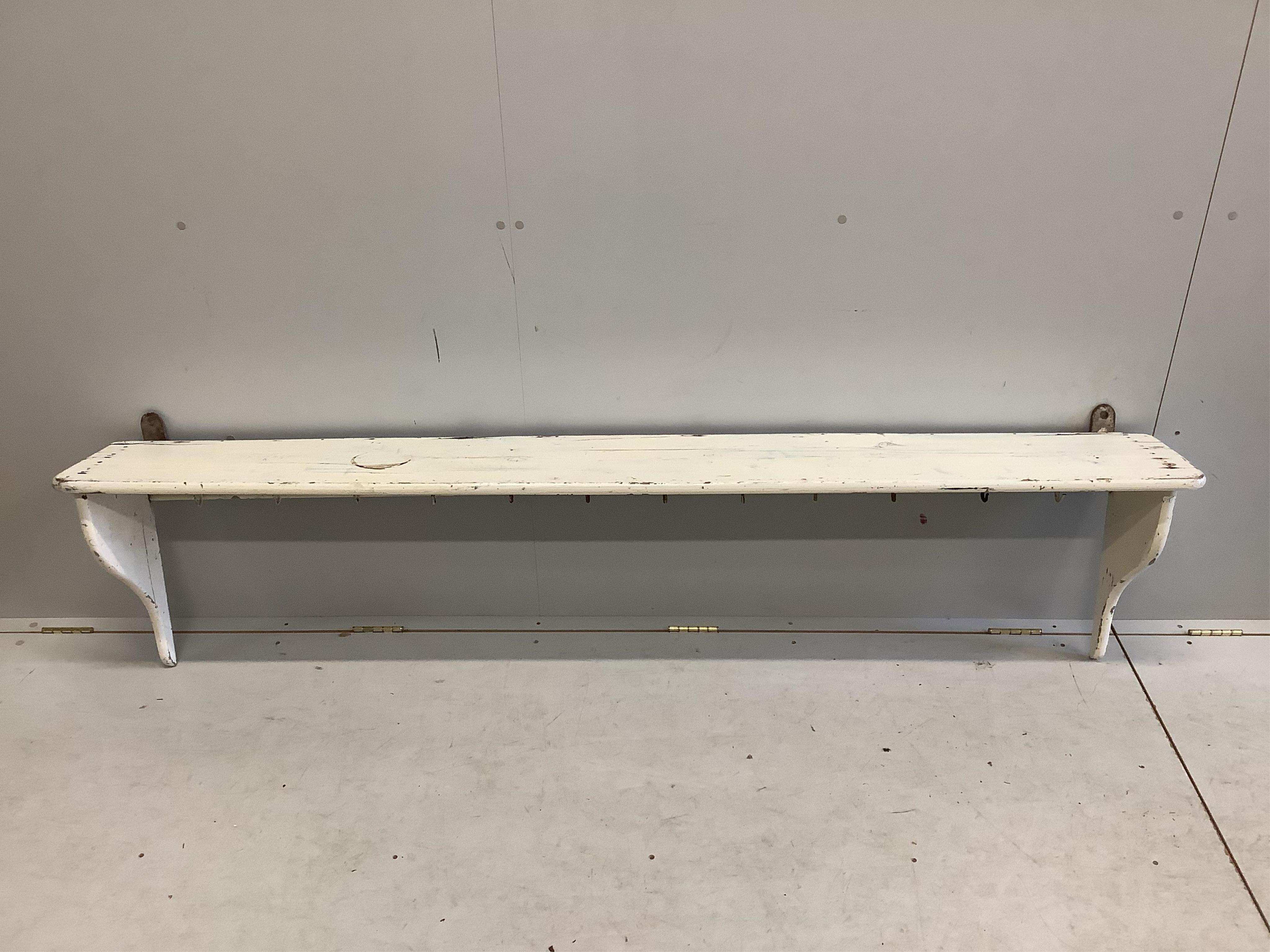 A painted hanging coat rack, length 200cm. Condition - fair